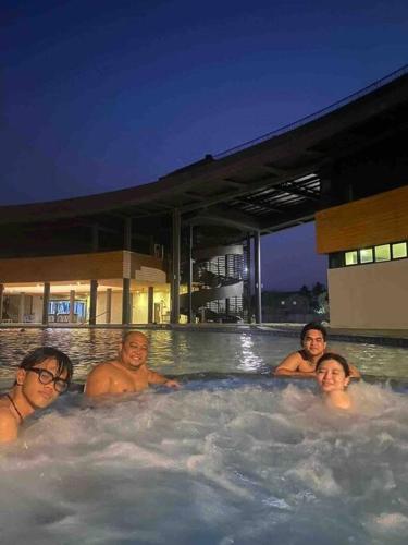 a group of people in a jacuzzi in a swimming pool at Beach Hive Seafront Villa at San Juan Batangas in Batangas City