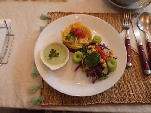 a white plate of food on a table at TRAVEL SURF NATURE in Tamraght Ouzdar
