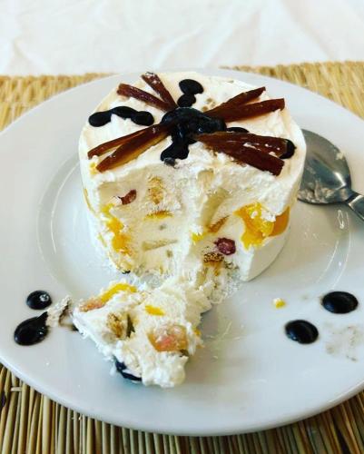 a piece of cake on a plate with a spoon at TRAVEL SURF NATURE in Tamraght Ouzdar