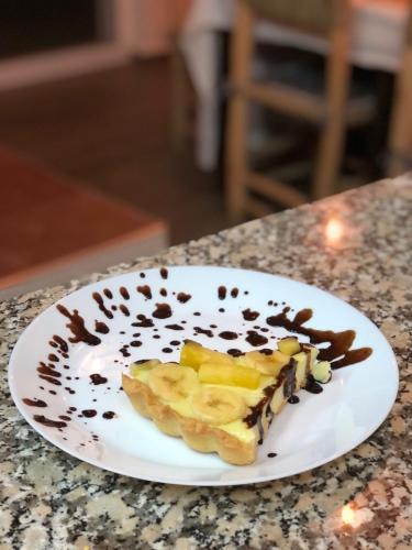 a white plate with a dessert on a counter at TRAVEL SURF NATURE in Tamraght Ouzdar