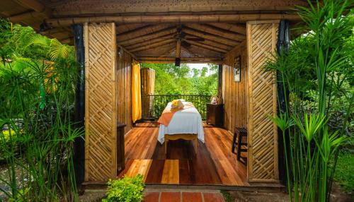 a room with a bed on a wooden deck at Decameron Panaca - All Inclusive in Quimbaya