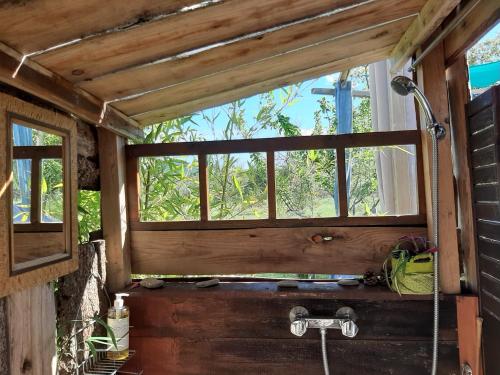 a bathroom with a window and a bath tub at la ruche in Grospierres