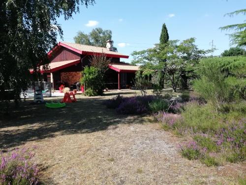 a garden with purple flowers in front of a building at MagHouse in Cestas