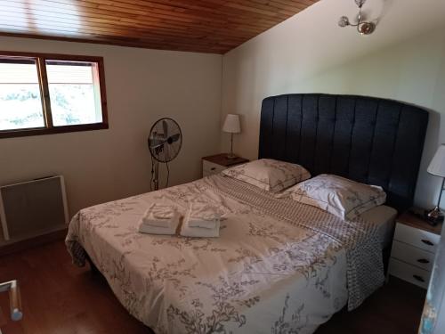 a bedroom with a bed with two towels on it at MagHouse in Cestas