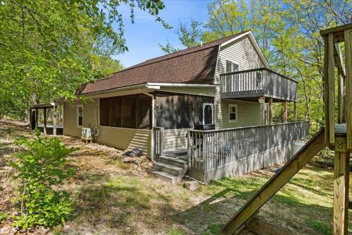 a small green house with a porch and a deck at In Resort Game Room - The Play House 5BR in McGaheysville