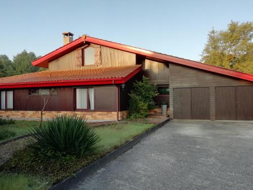 a house with a red roof and a garage at MagHouse in Cestas
