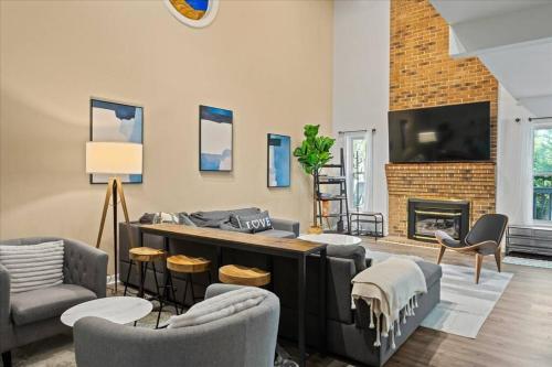 a living room with a couch and a fireplace at In Resort Game Room - The Play House 5BR in McGaheysville