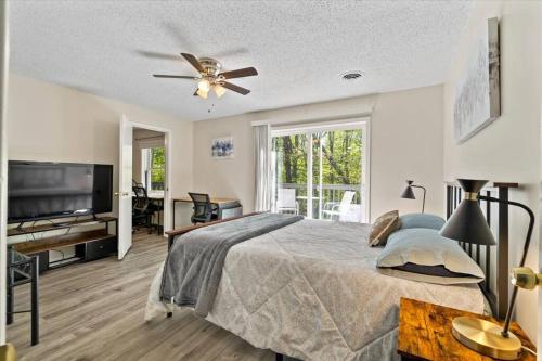 a bedroom with a bed and a flat screen tv at In Resort Game Room - The Play House 5BR in McGaheysville