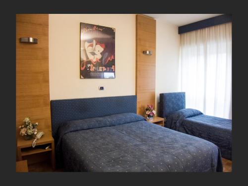 Ένα ή περισσότερα κρεβάτια σε δωμάτιο στο Hotel Clarici