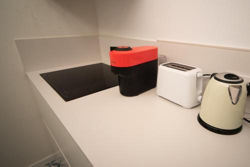 a small kitchen with two trash cans and a toaster at Private room By BCN Center in Barcelona