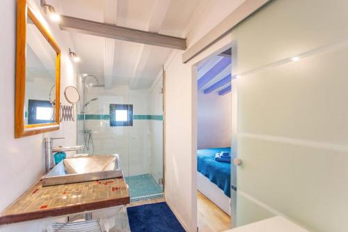 a small bathroom with a sink and a shower at Bluehouse Portixol in Palma de Mallorca