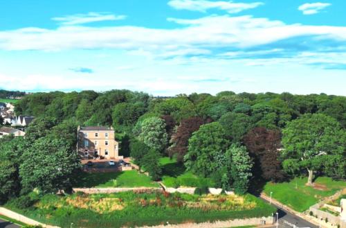 an aerial view of a house in the middle of a forest at Morven Guest House Carnoustie in Carnoustie