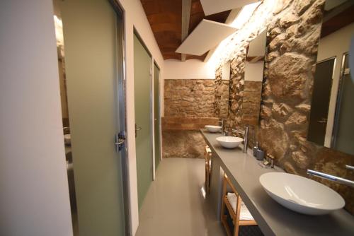a bathroom with two sinks and two mirrors at Villa Masia Capdet in Sant Pere de Ribes