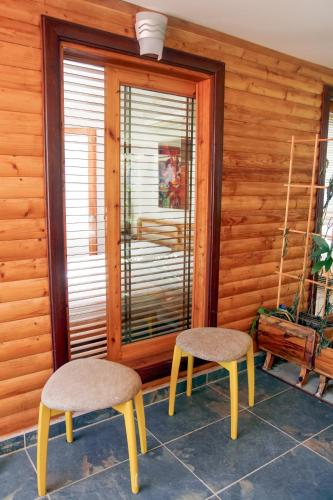 a room with two chairs and a window at Chimera Pia Aparts in Cıralı