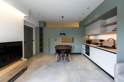 a kitchen with a table in the middle of a room at Studio w/king size bed near the Heart of Kalamata in Kalamata