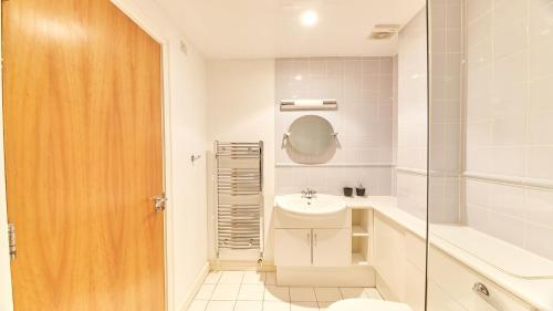 a white bathroom with a sink and a toilet at High Quays - Properties Unique in Newcastle upon Tyne