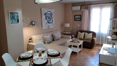 a living room with a couch and a table at La Colina Golf & Beach in Huelva