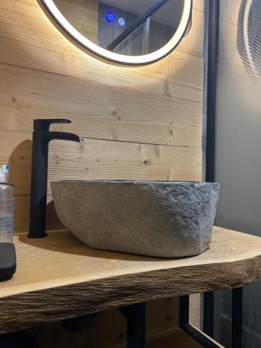 a stone sink on a counter with a mirror at Chalet deS'AMY et sa terrasse pour 8/10 personnes in Font-Romeu-Odeillo-Via