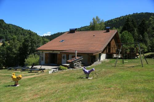 a house with some toy animals in the yard at La Ferme du Douanier & Spa 5 étoiles ALL INCLUSIVE in Ventron