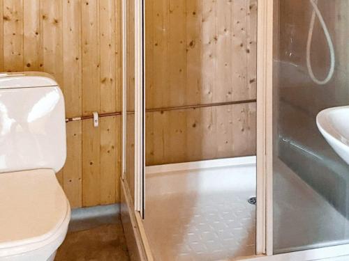 a bathroom with a shower and a toilet and a sink at Holiday home TORPSHAMMAR in Torpshammar