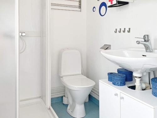 a white bathroom with a toilet and a sink at 6 person holiday home in Mönsterås-By Traum in Mönsterås