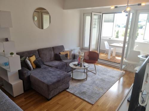 a living room with a couch and a table at Luxury apartment Sunny place in Mostar