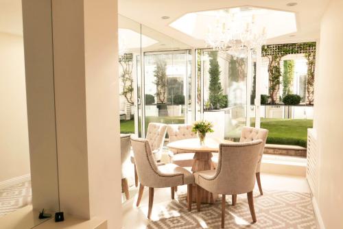 a dining room with a table and chairs at Belgravia flat, with private Terrace in London