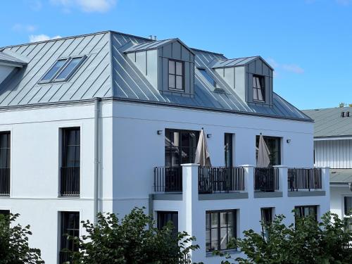 a house with solar panels on the roof at Gustav Appartements in Binz