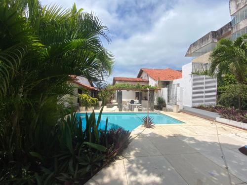 a swimming pool in the backyard of a house at Casa Beira Mar Itamaracá in Itamaracá