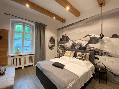 una camera con un grande letto e una grande finestra di ciao-aschau Haus zur Burg FeWo Bergfest Ap110 a Aschau