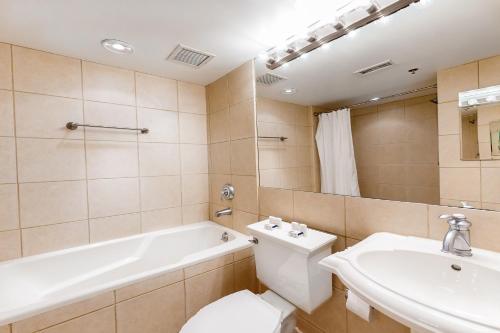 a bathroom with a toilet and a tub and a sink at Hiawassee E302 in Asheville