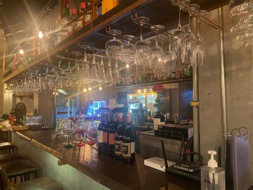 a bar with many wine glasses hanging above it at Big Boys' Bed & Burger - Patong Beach in Patong Beach