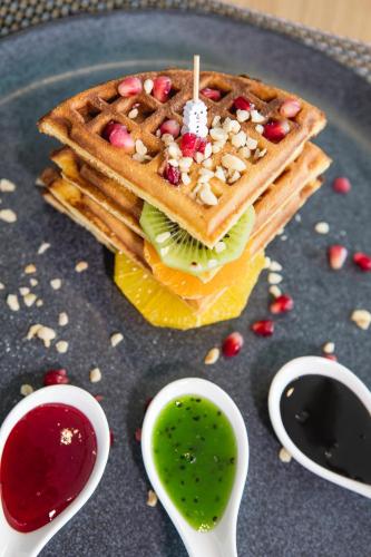 a waffle sandwich on a plate with sauce at Hilton Garden Inn Safranbolu in Safranbolu