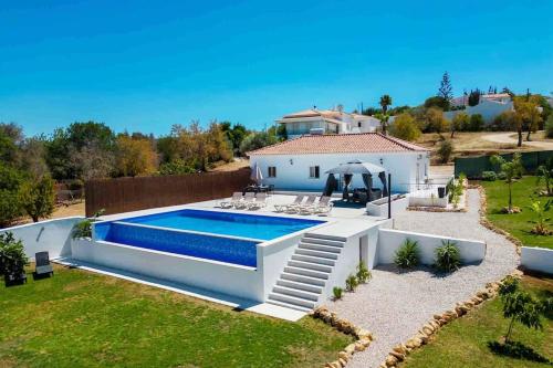 a house with a swimming pool in a yard at Casa Emella Luxury Villa Albufeira in Albufeira