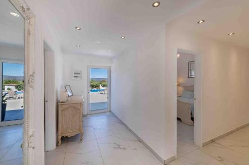 a white hallway with a desk and a bedroom at Casa Emella Luxury Villa Albufeira in Albufeira