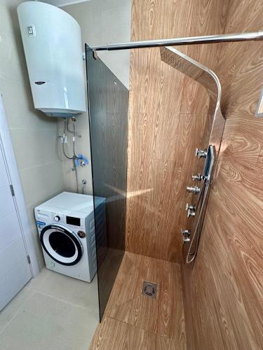 a bathroom with a washing machine and a washer at Apartment Stex 2 in Podgorica