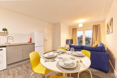 a kitchen and a living room with a table and chairs at The Norham - Properties Unique in North Shields