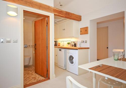 a kitchen with a washer and dryer at The Lavendrye in Wadhurst