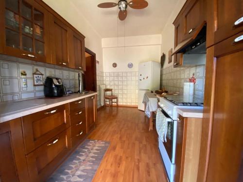 a large kitchen with wooden floors and wooden cabinets at Polly Garden in Rome