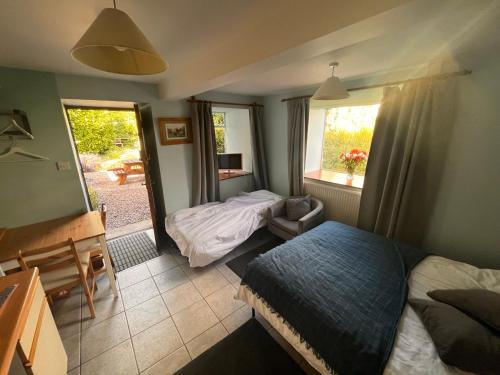 a bedroom with a bed and a bed and a window at Riverside apartment in Brecon