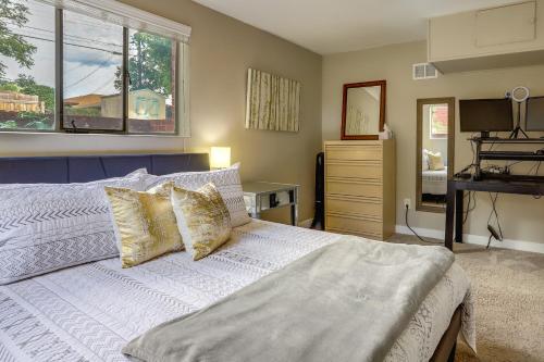a bedroom with a white bed with a window at Denver Vacation Rental Near Parks and Attractions! in Denver