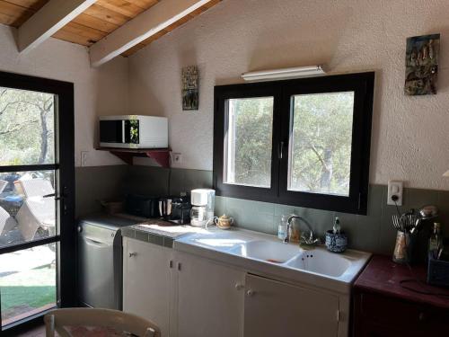 a kitchen with a sink and a window at Véritable Bastidon Provençale in Le Tholonet