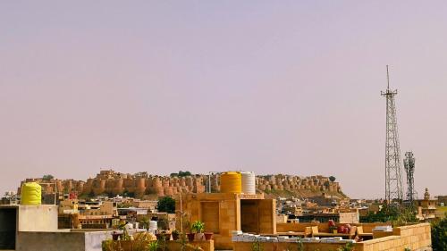 a view of a city with a mountain in the background at Bob Cafe & Guest House Jaisalmer in Jaisalmer