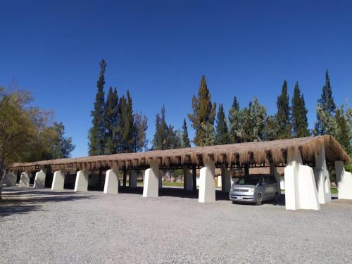 a car parked under a pavilion with a roof at Cabañas La Huayca - Caja Los Andes in Pica