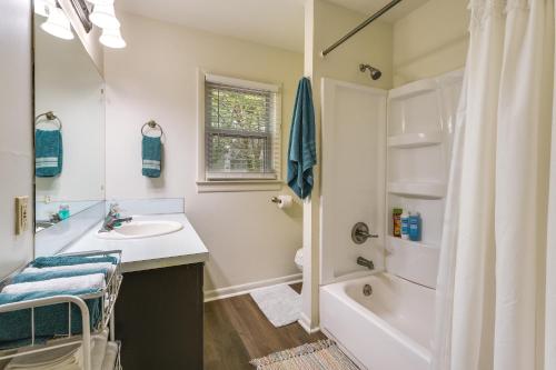 a white bathroom with a sink and a shower at Springfield Home with Yard 3 Mi to Downtown! in Springfield