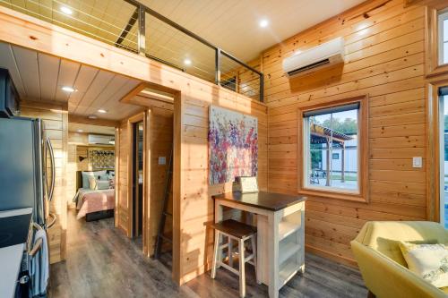 a tiny house with a desk and a bedroom at about 11 Mi to Lake Whitney Tree-Lined Cabin with Deck in Whitney
