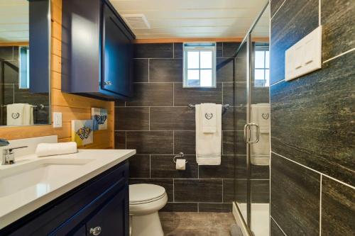 a bathroom with a toilet and a glass shower at Tree-Lined Whitney Cabin about 11 Mi to Lake Whitney! in Whitney