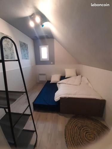 a small bedroom with a bed and a ladder at Le bien être aux forges in Céaux