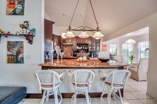 a kitchen with a large island with four chairs at Villa Sweet Dreams, Cape Coral in Cape Coral