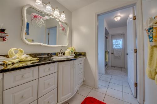 a bathroom with a sink and a mirror at Villa Sweet Dreams, Cape Coral in Cape Coral